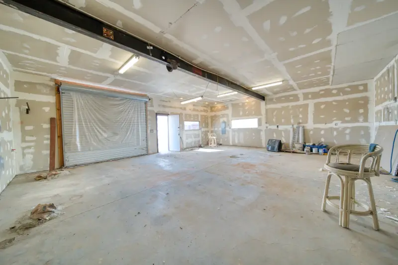 Room stripped to bare drywall during restoration