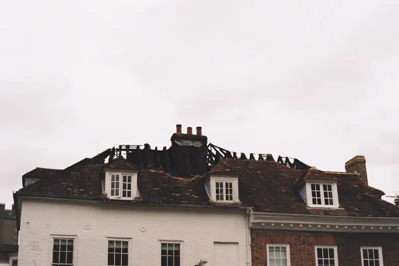 Fire-damaged roof with charred beams