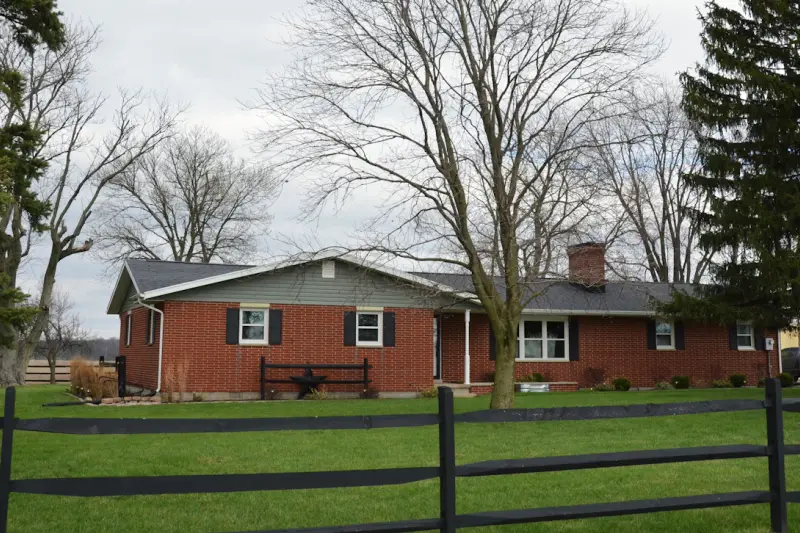Brick ranch house with a fenced yard