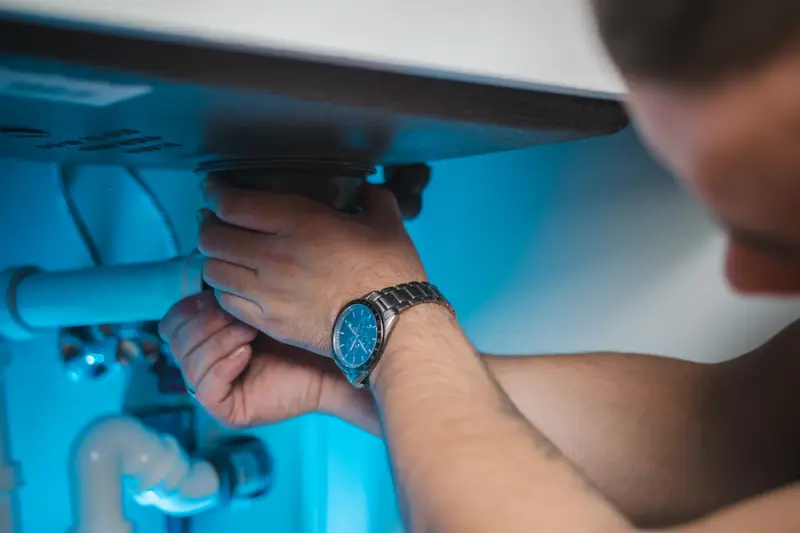 Technician working on water heater plumbing